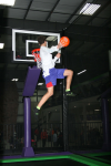 Man One Hand Windmill Dunking on Trampoline Basketball Court